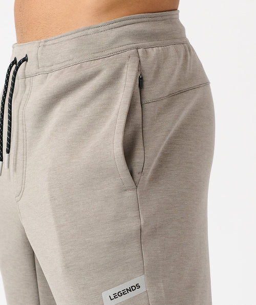 Taupe heather joggers with drawstring waist, side pockets, and "Legends" label on leg.
