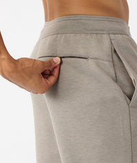 Taupe heather joggers with elastic waistband and side pocket, shown from waist to thigh on model.