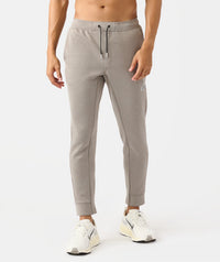 Men's taupe heather joggers with drawstring waist and tapered ankles.