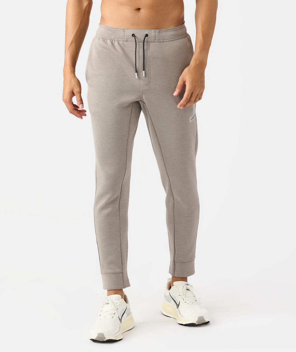 Men's taupe heather joggers with drawstring waist and tapered ankles.