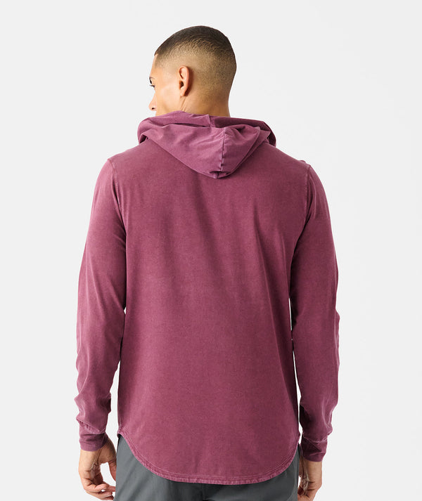 Washed fig long-sleeve hooded tee with curved hem, shown from back on model.