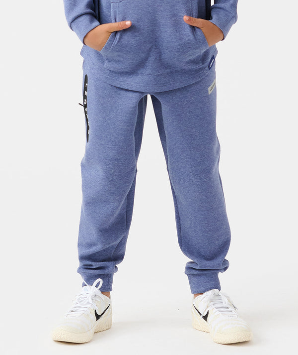 Child wearing heather blue joggers with ribbed cuffs and side pocket details, paired with white sneakers.
