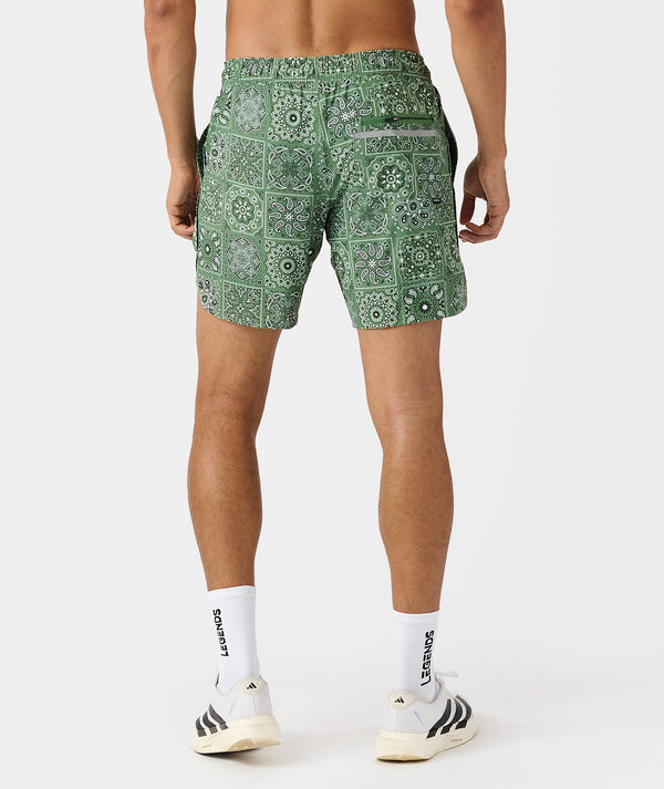 Men's shorts in green with white paisley tile pattern, back view.