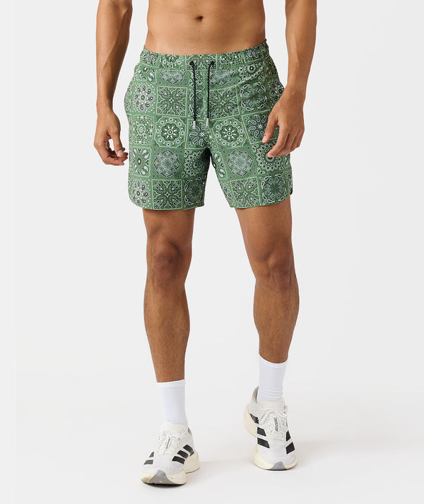 Men's shorts with green paisley tile pattern, drawstring waist, and side pockets.