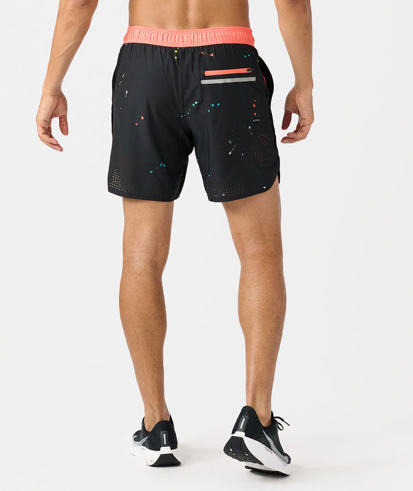 Black shorts with coral pink waistband, colorful speckled pattern, and back pocket detail.