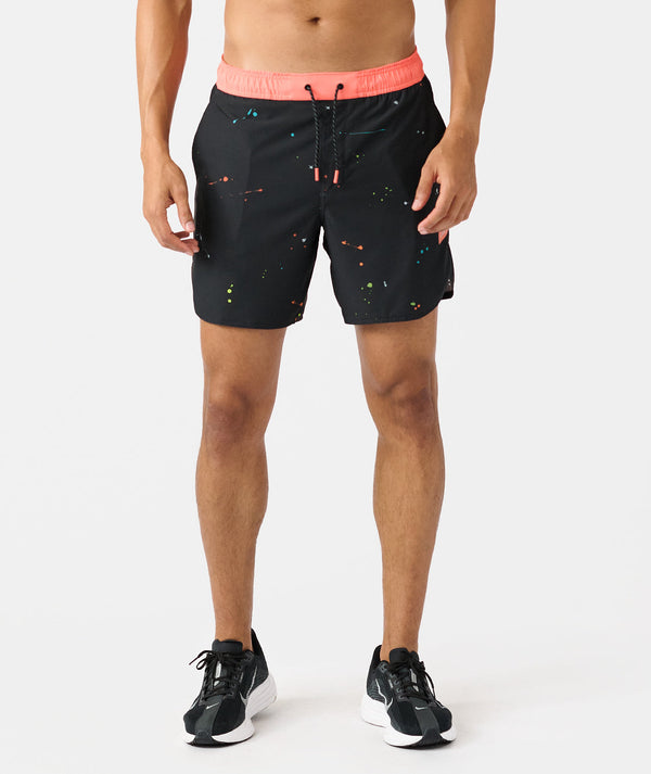 Black shorts with multicolored speckled pattern and coral pink waistband with drawstring.