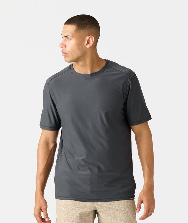 Man wearing charcoal gray short-sleeve crew neck t-shirt with beige shorts.