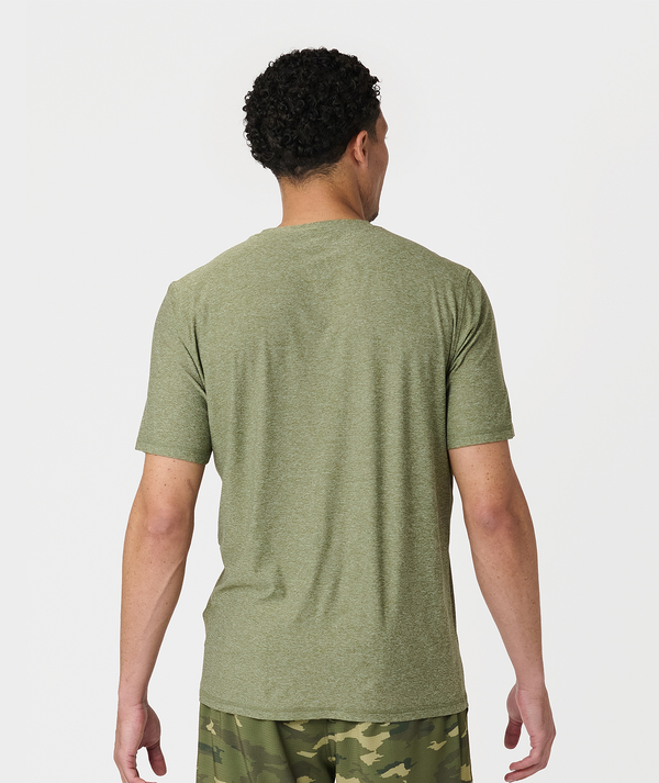 Man wearing cypress heather short-sleeve t-shirt, shown from back view.