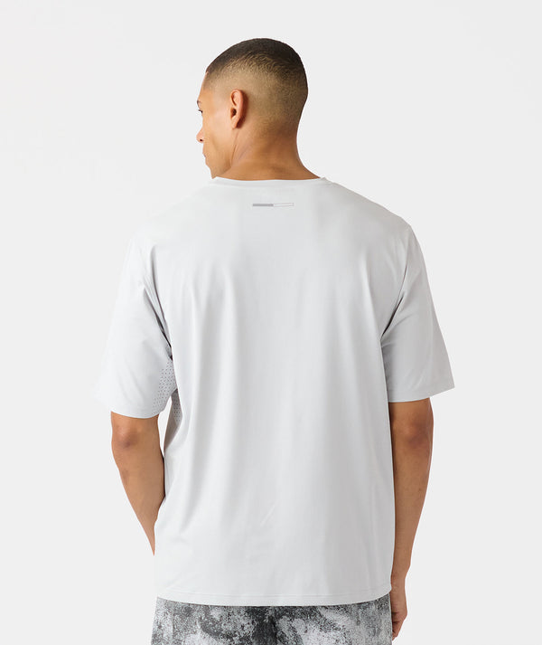 White short-sleeve t-shirt with perforated side panels, shown from back view on male model.
