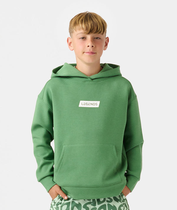 Child wearing a green hoodie with "LEGENDS" text label on chest and front pocket.