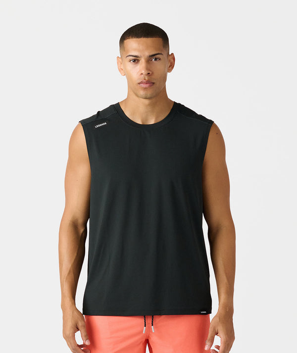 Black sleeveless tank top with crew neckline on male model wearing coral shorts.
