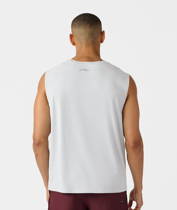 White sleeveless tank top with small logo on back, paired with burgundy shorts.