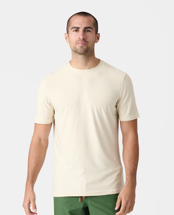 Man wearing dune heather short-sleeve crewneck tee with green shorts.