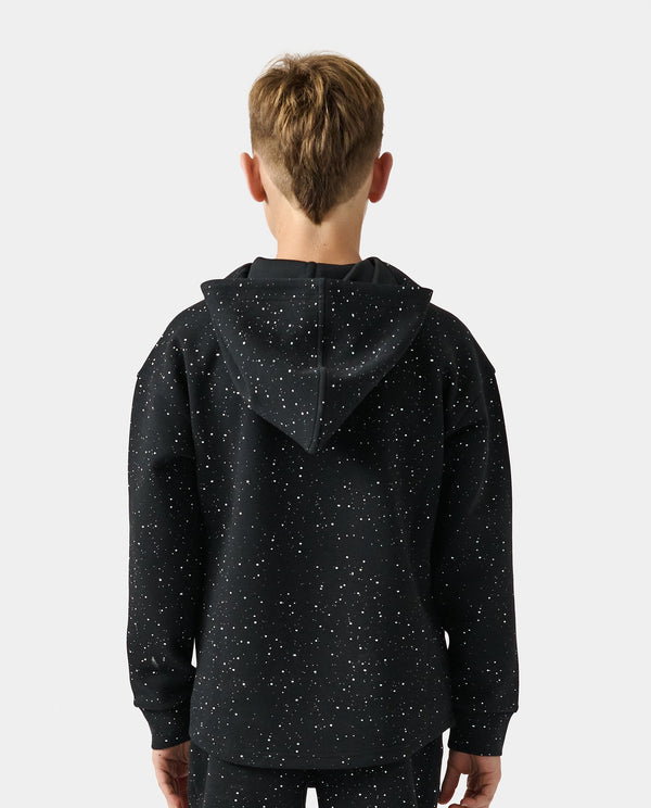 Child wearing black hooded quarter zip sweatshirt with white splatter print throughout, shown from back view.
